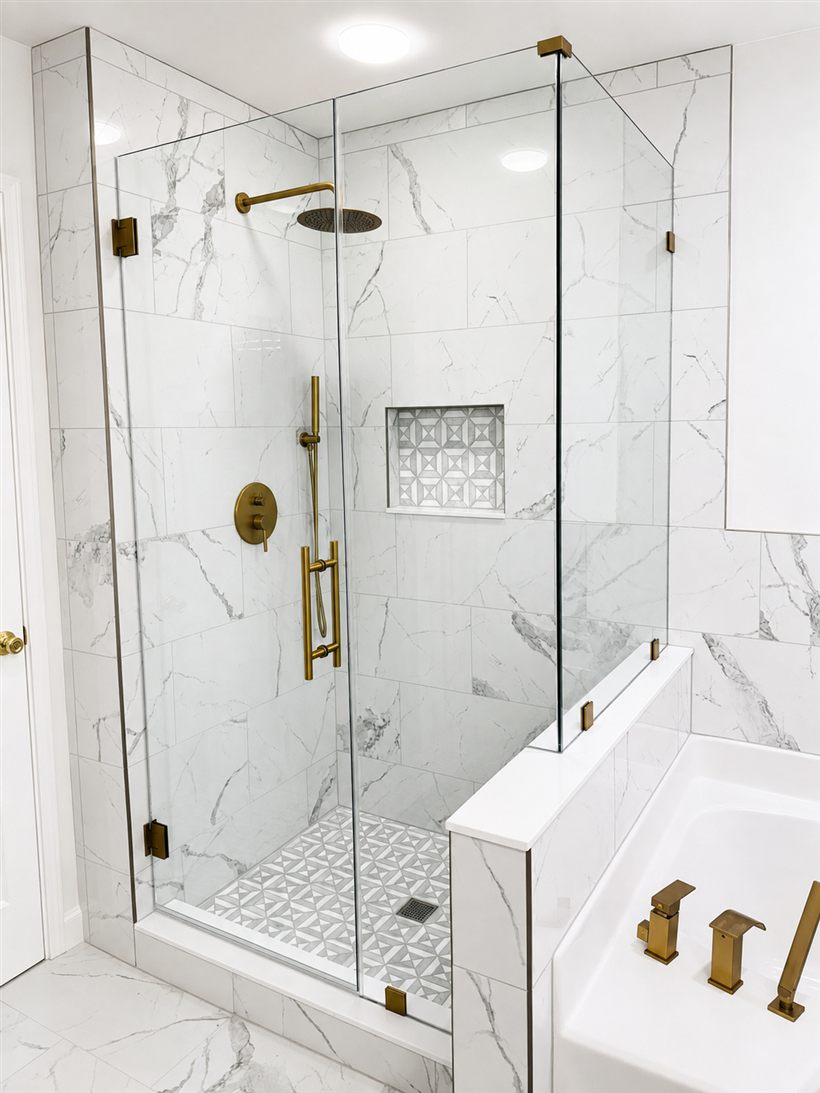 Frameless glass shower enclosure built over a half wall